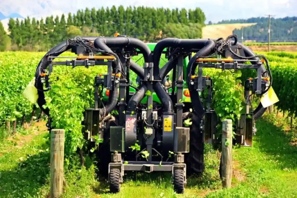 Agricultural equipment operating between crop rows, illustrating the physical environment connected by the NuPoint platform.